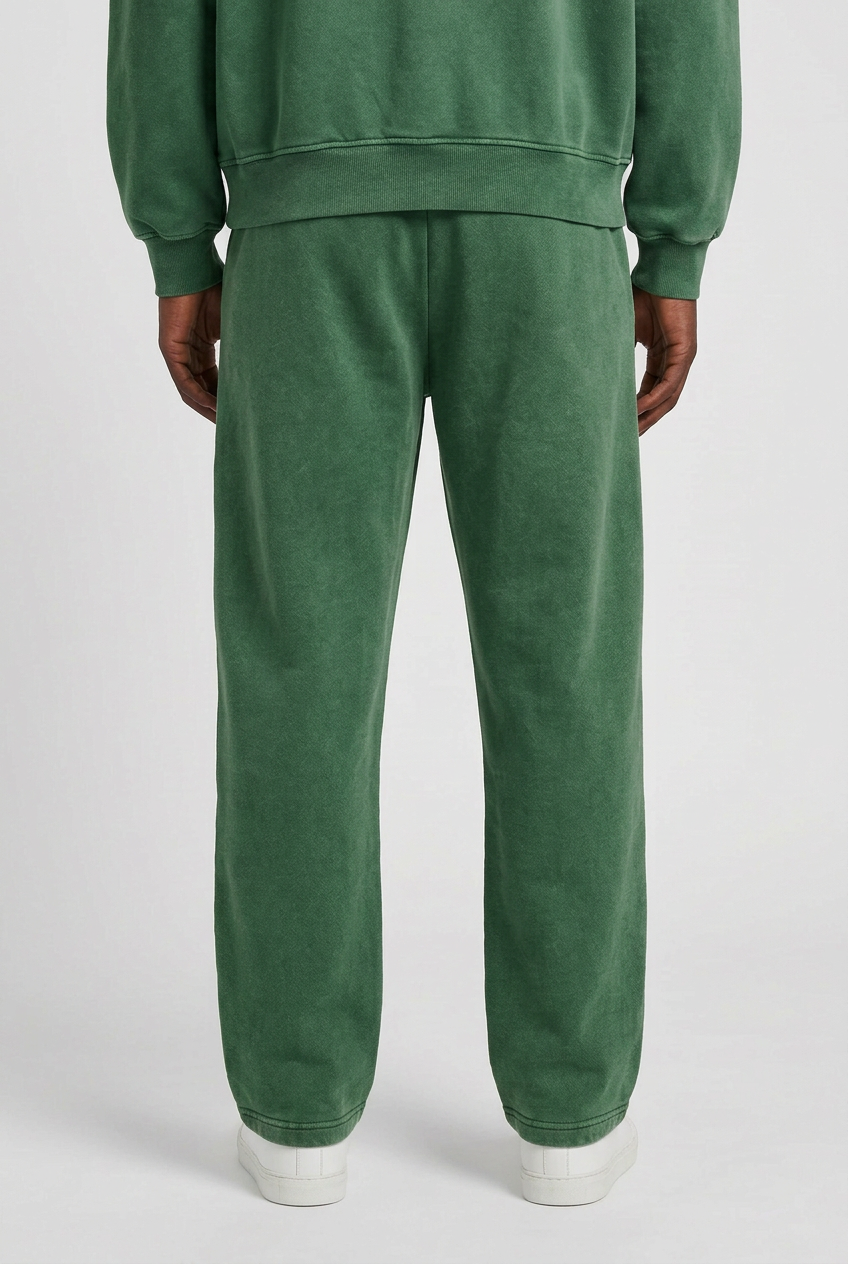 Back close-up of Groundwork Forest Green pants on same model wearing matching hoodie