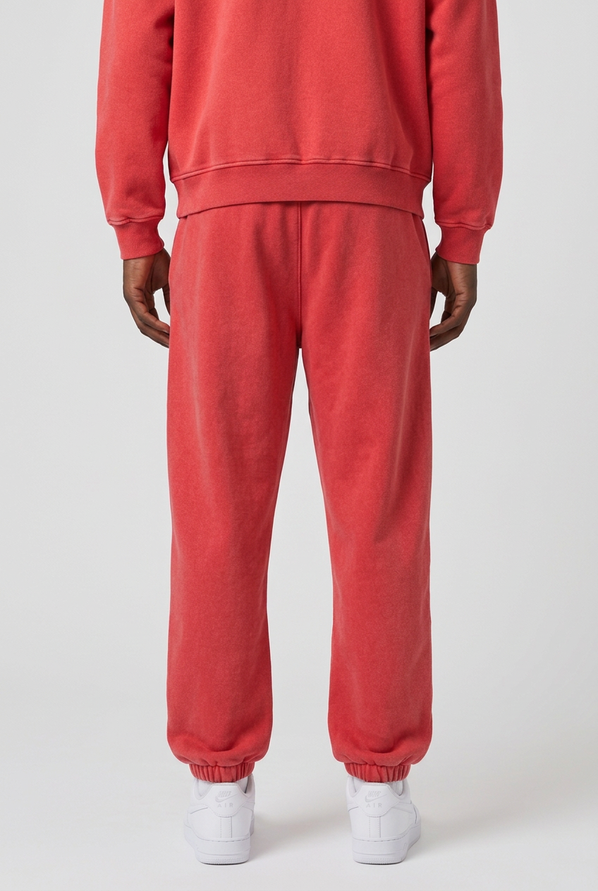 Back close-up of plain-back Statement Red sweatpants worn with matching red zip hoodie