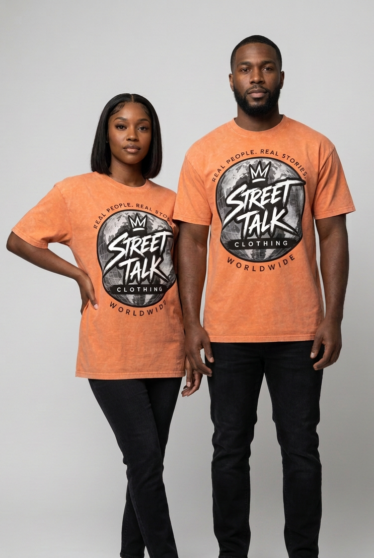 Couple wearing matching Quiet Motion Orange Ash Wash tees with black denim jeans