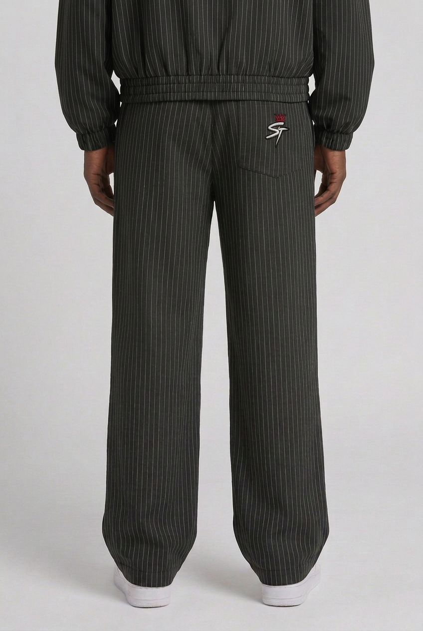 Back close-up of loose wide-leg Uptown Midnight Black trousers with matching jacket worn