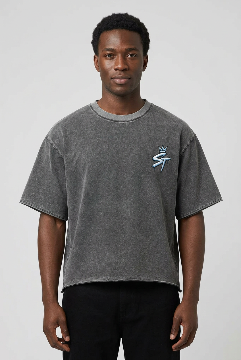 Male model wearing the Ground Level Tee in Ash Gray with original crowned ST chest artwork