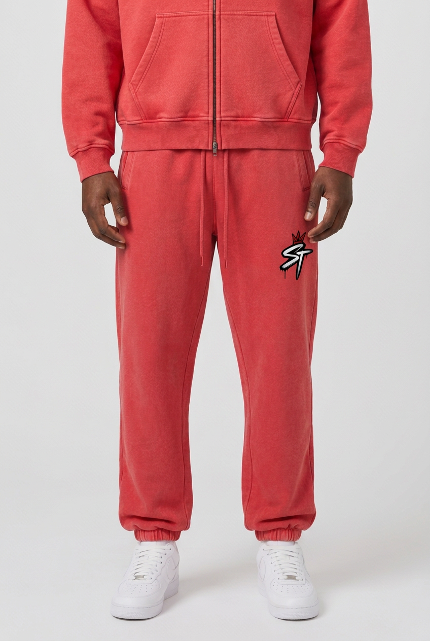 Front close-up of Statement Red sweatpants with crowned ST logo, worn with matching zip hoodie